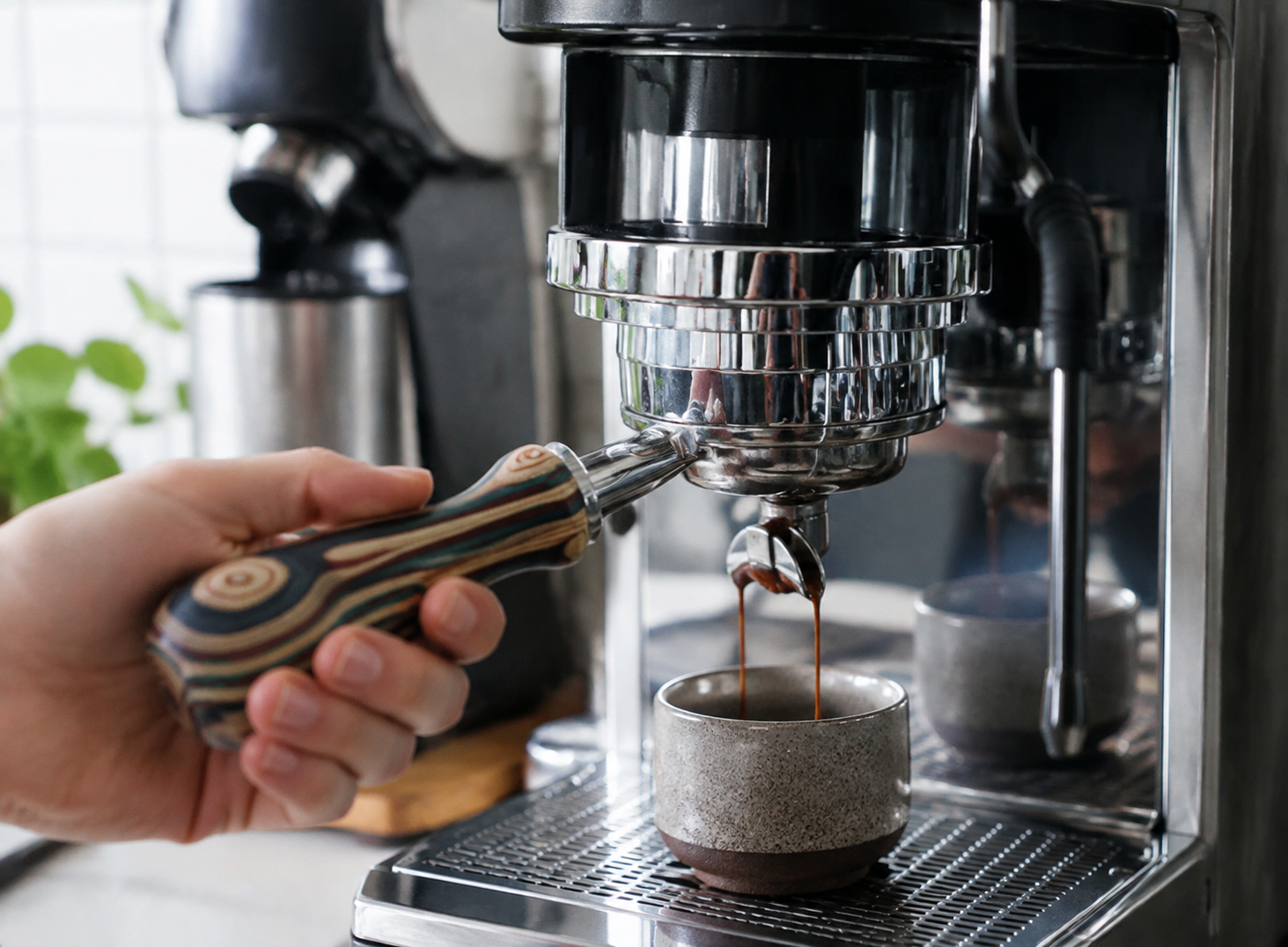 58mm bottomless portafilter with pakkawood handle pulling a shot, in use